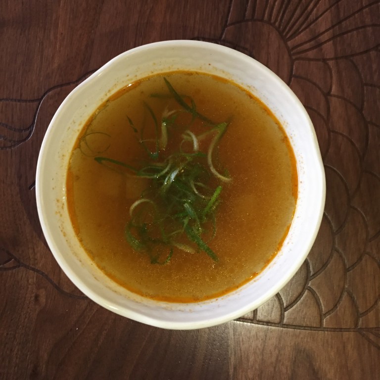 Kimchi broth with daikon, carrots, and green onions